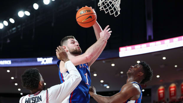 Mar 9, 2024; Houston, Texas, USA; Kansas Jayhawks center Hunter Dickinson (1) attempts to score as Houston Cougars guard Mylik Wilson (8) defends during the first half at Fertitta Center.